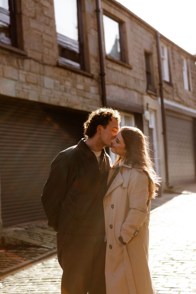 a couple during an engagement photoshoot on the streets of edinburgh