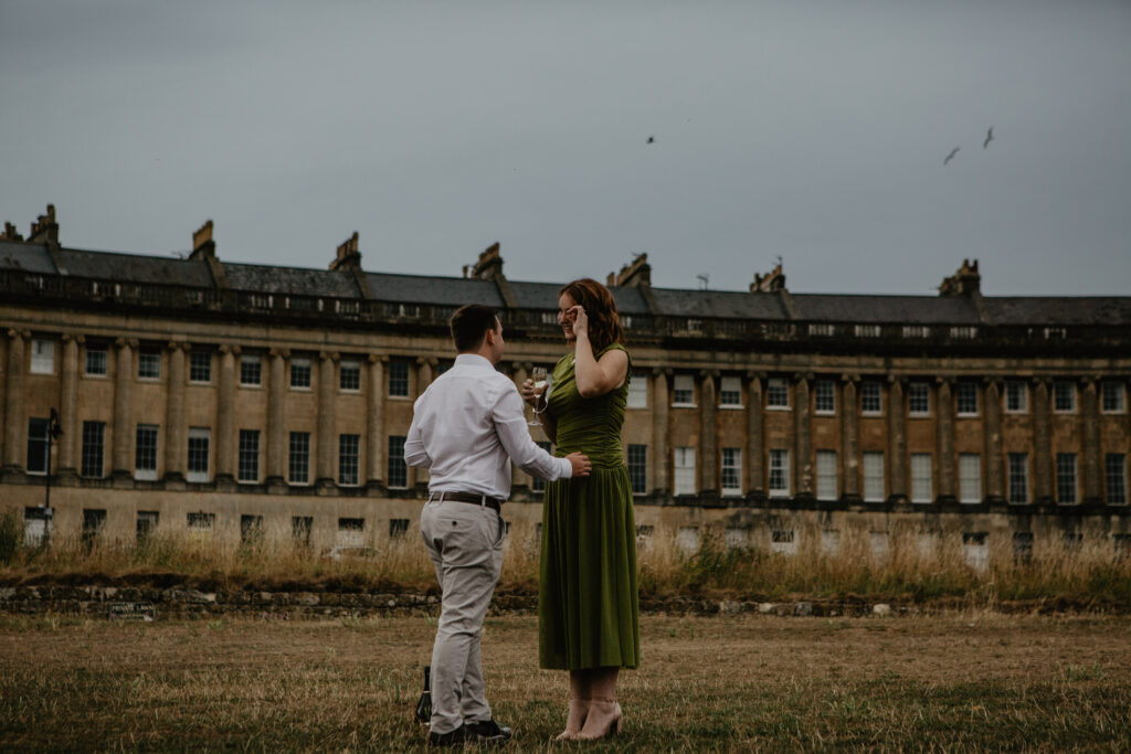 a couple sharing champagne after a proposal in bath 