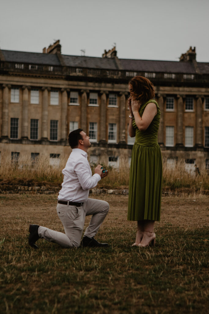 a man on one knee during a surprise proposal photoshoot to his girlfriend in bath