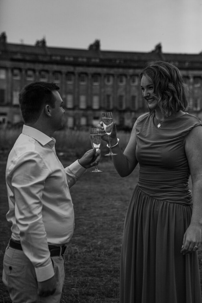 a couple sharing champagne after a proposal in bath 