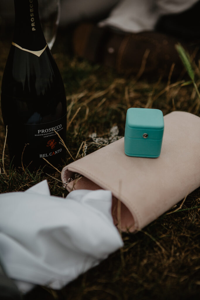 champagne and a ring photographed during a surprise proposal