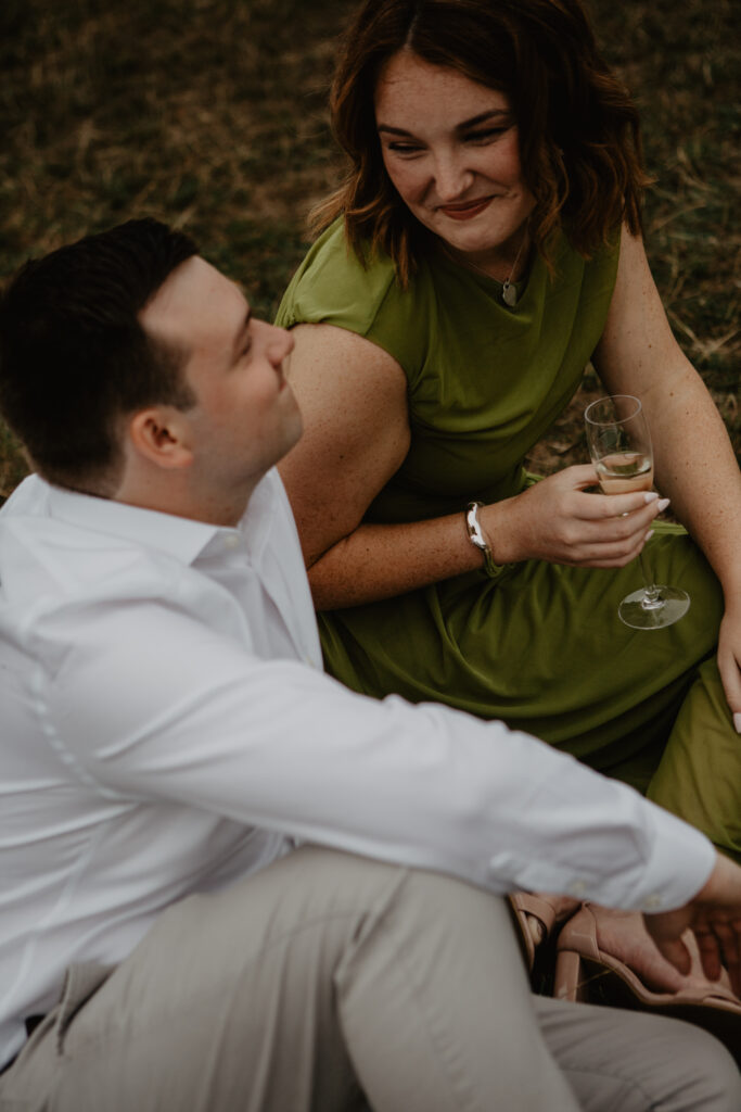 a couple sharing champagne after a proposal in bath 