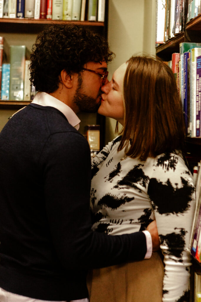 a couple kissing in a library  during a couples photoshoot in bristol